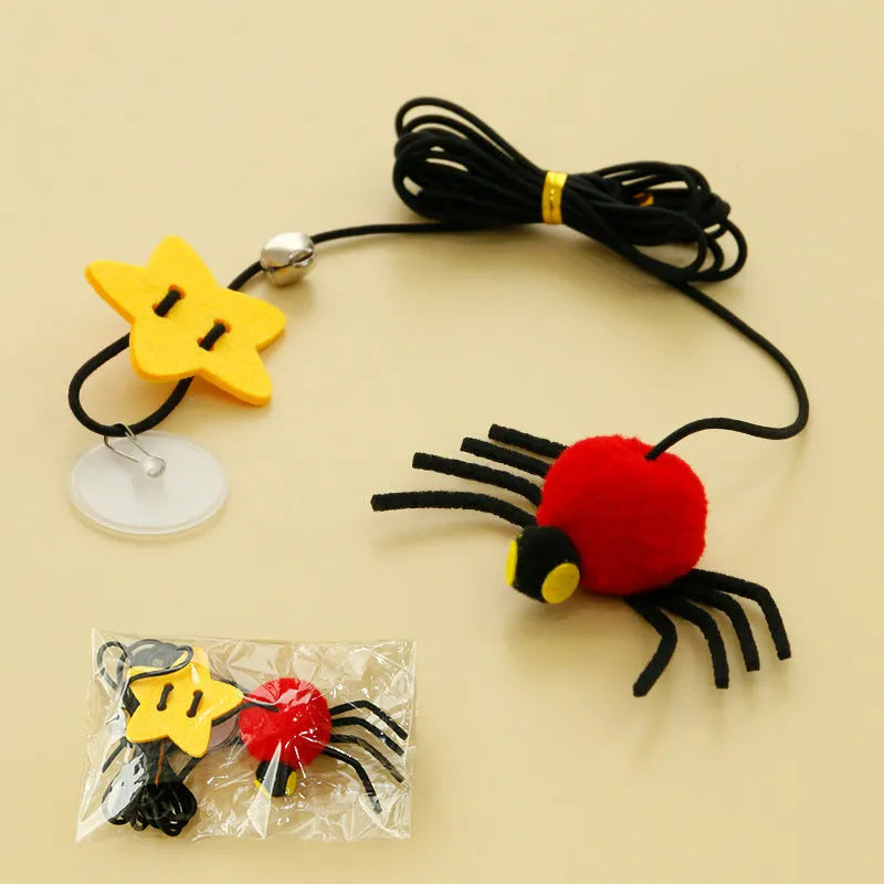 Cat door hanging toy with elastic rope, feather, bell, and spider design in red colour