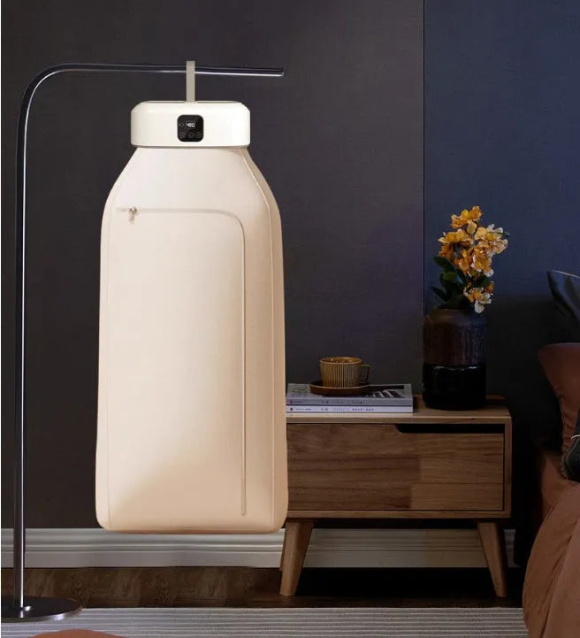 White foldable portable clothes dryer with remote control on countertop
