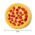 Yellow pizza slice shaped rubber dog chew toy with textured ridges and a squeaker.