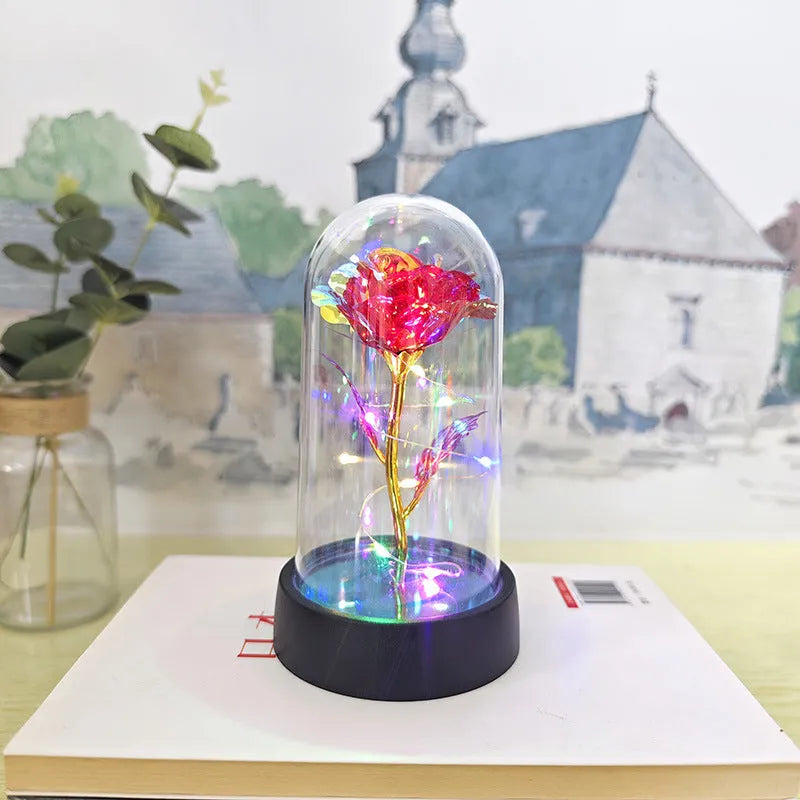 Small plastic night lamp with floral decoration and coloured light options on a black base.