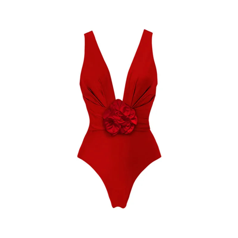 Red women's V-neck one-piece swimsuit with detachable flower and matching skirt on beach