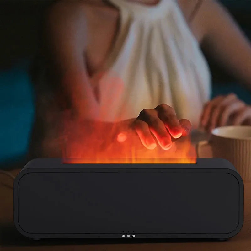 Black and white aroma diffuser with dynamic flame LED light effect on a table.