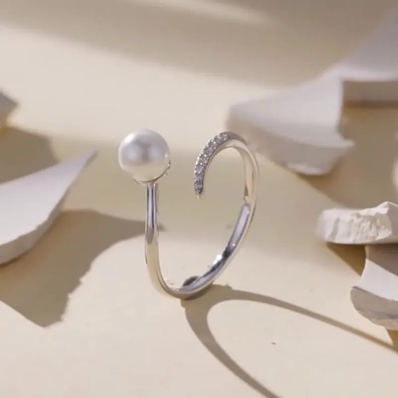Women's adjustable sterling silver ring with natural pearl on open loop design