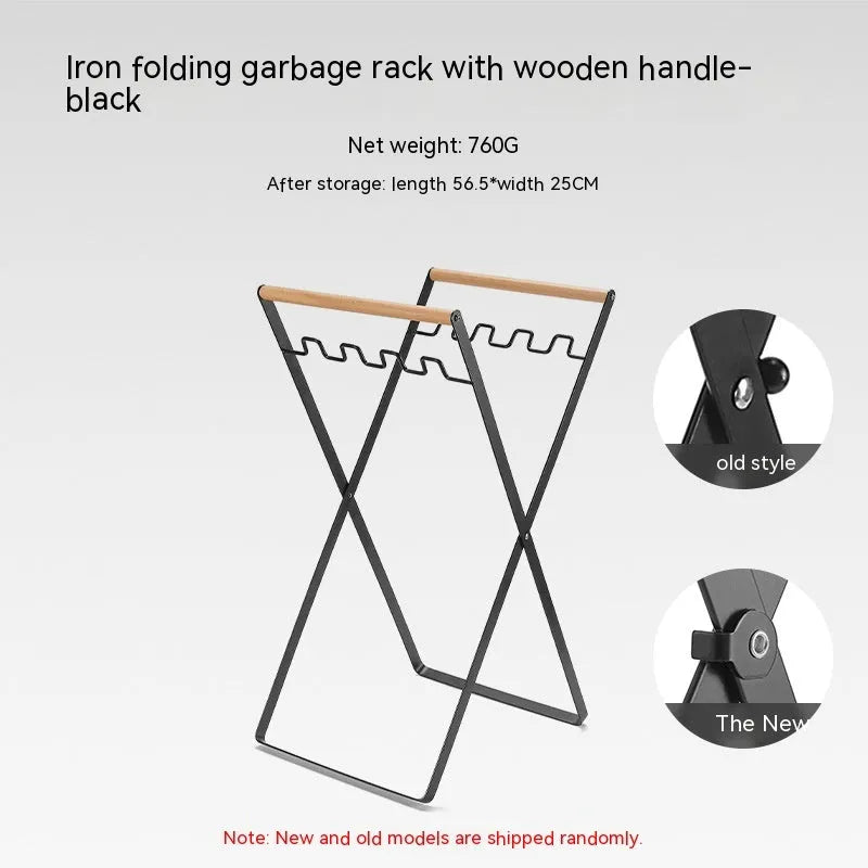 Black iron folding storage rack with a wooden handle for hanging outdoor waste bags.