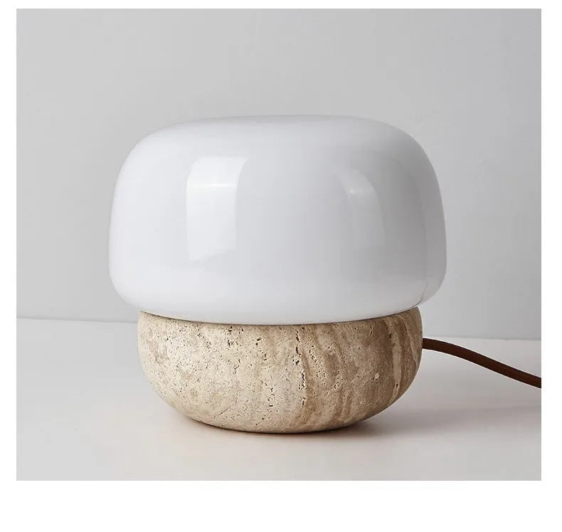 Cream-coloured retro style bedside table lamp with a warm white glow.