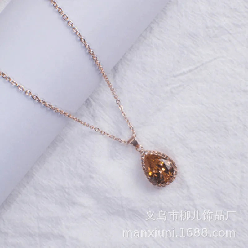Pink water drop geometric necklace with rose gold electroplating and rhinestone detailing on alloy pendant