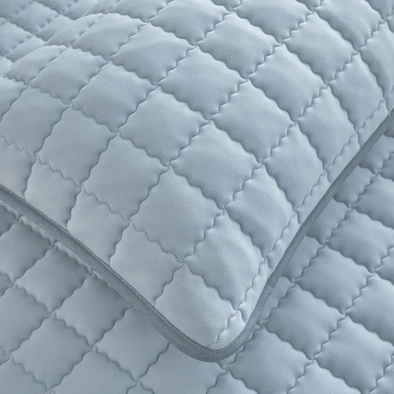 Blue washed cotton waterproof fitted sheet with elasticated corners shown on mattress