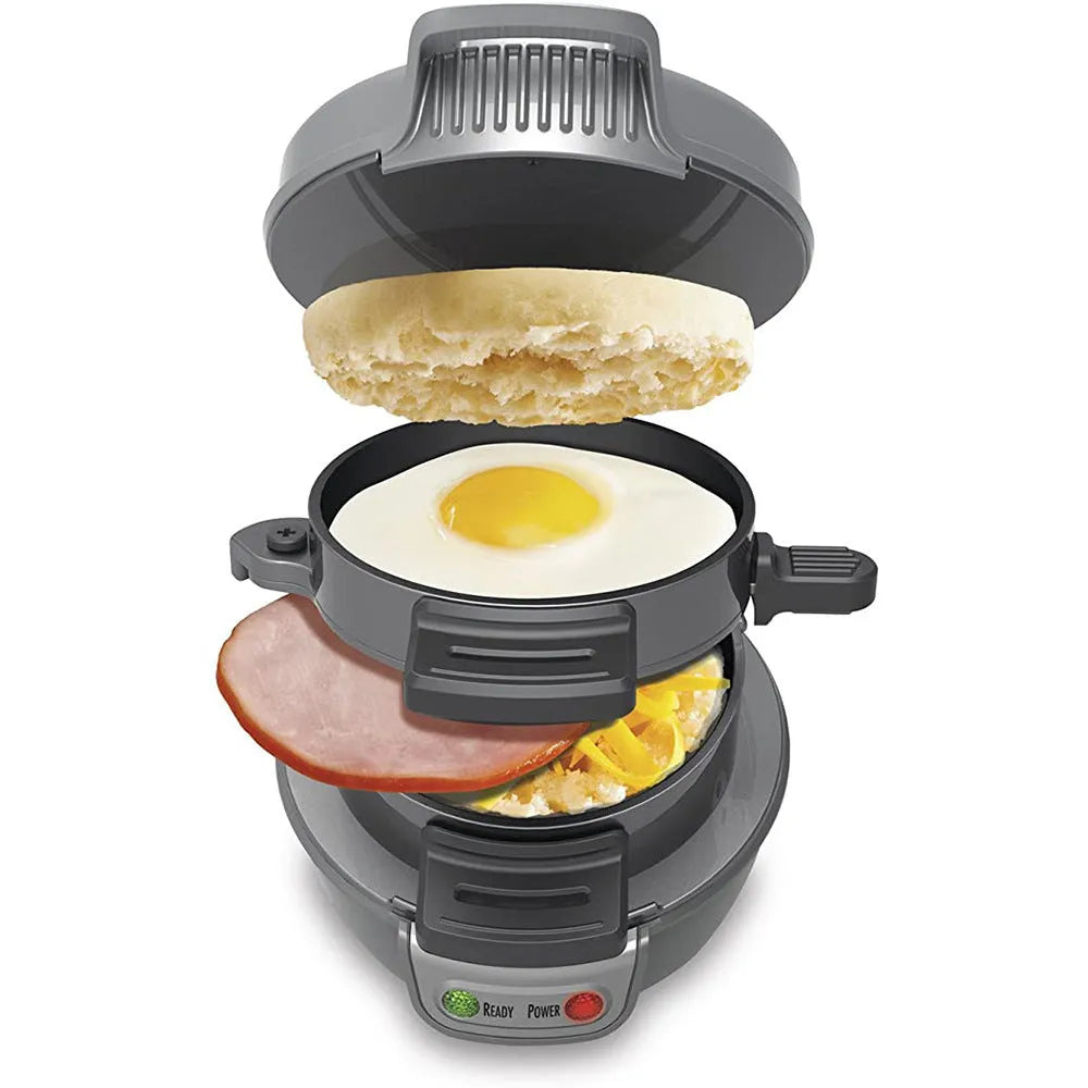 Silver grey household breakfast machine sandwich toaster with waffle plates and egg cooker ring on a kitchen counter.