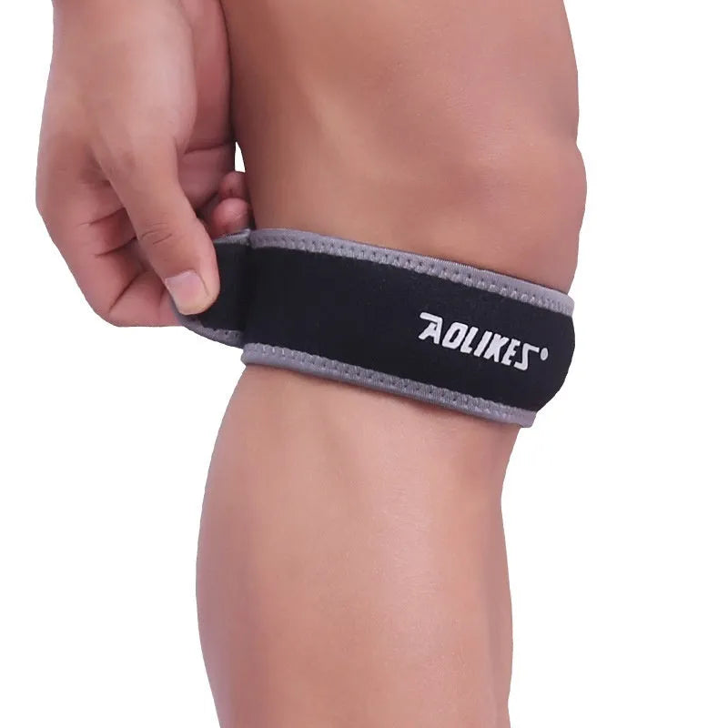 Black and grey adult patella retinaculum knee support bandage for sports.