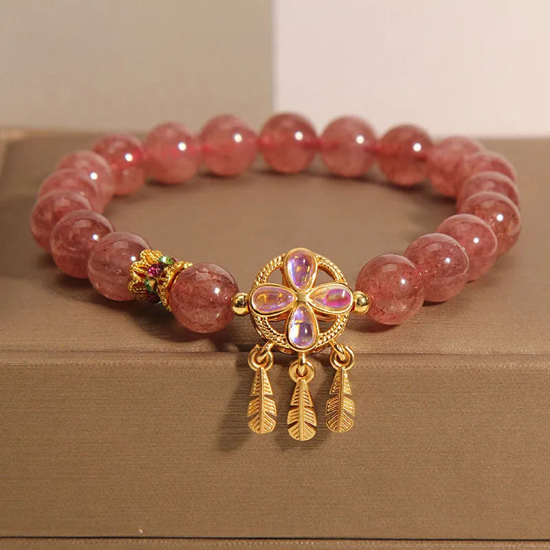 Women's strawberry quartz crystal bracelet with four leaf dream catcher ball pendant in natural rose pink colouration