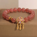 Women's strawberry quartz crystal bracelet with four leaf dream catcher ball pendant in natural rose pink colouration