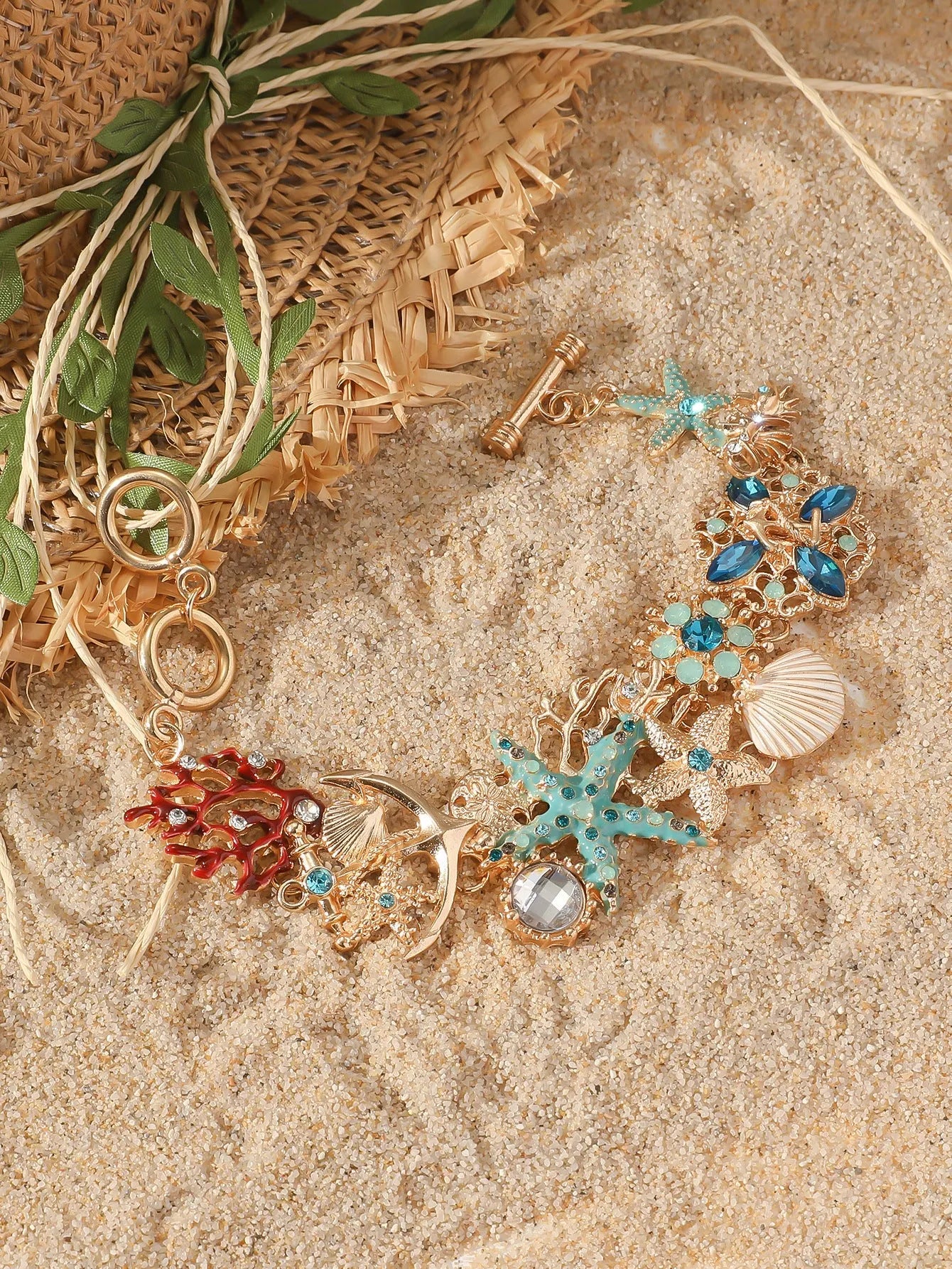 Women's alloy rhinestone bracelet with boat anchor, shell, and starfish charms in blue.