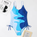 Women's sleeveless backless one-piece swimsuit in blue, shown on a mannequin.