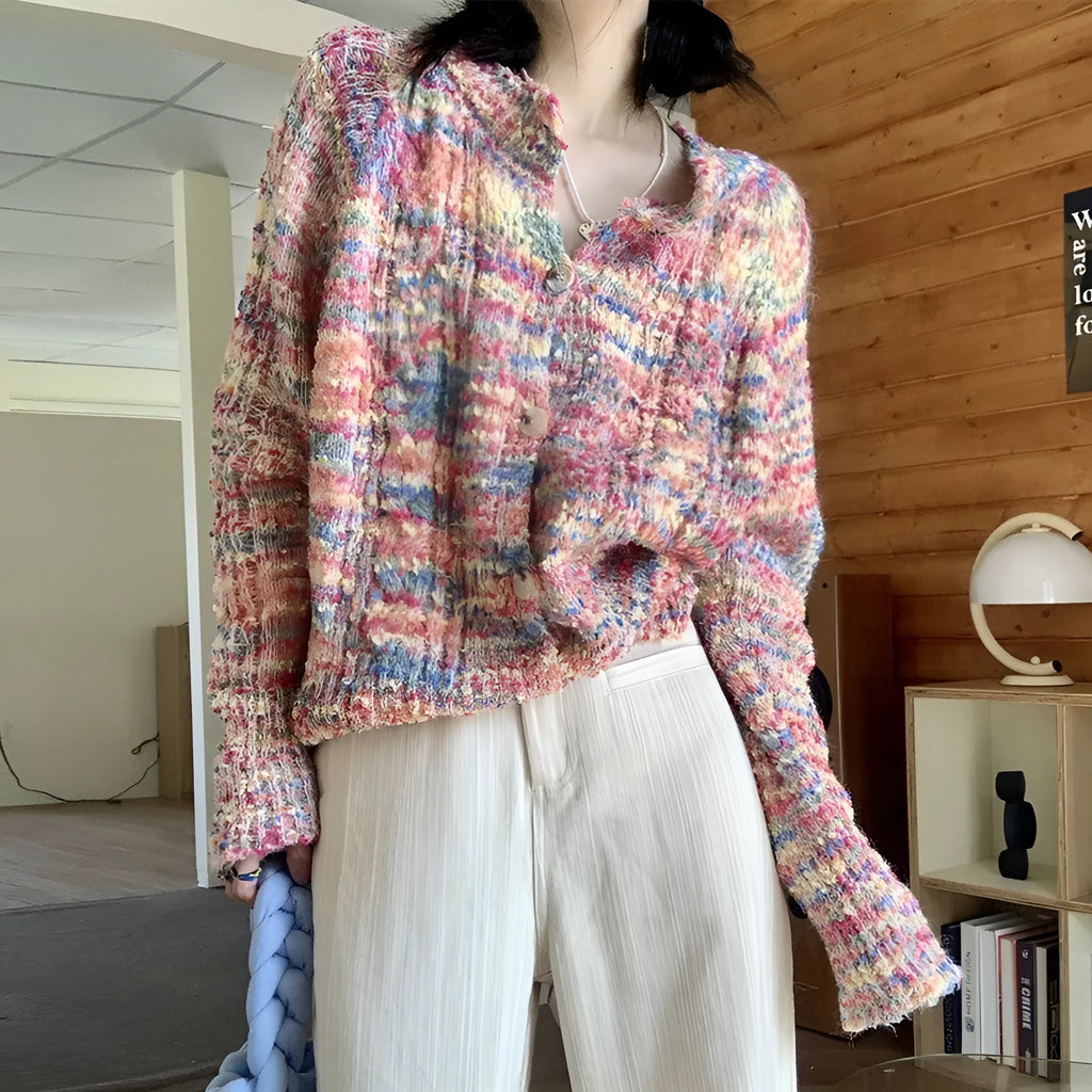 Pink and green retro style slim-fit knitted cardigan sweater on a hanger.