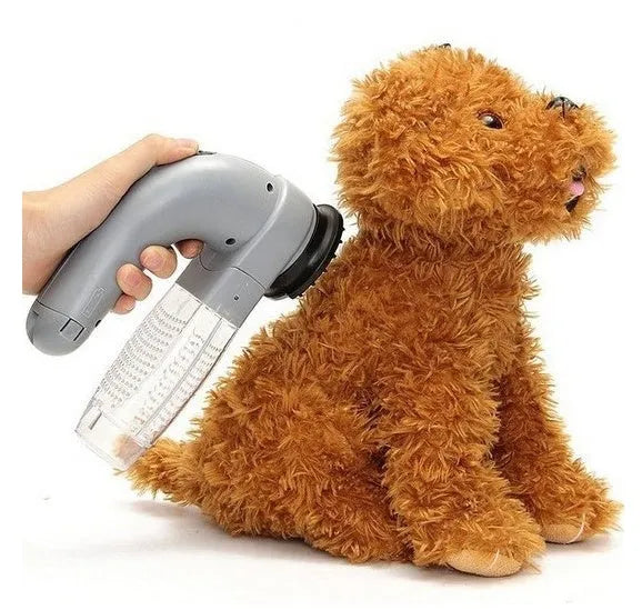 Grey portable pet hair vacuum cleaner with soft rubber head and large collection canister on a fabric sofa.