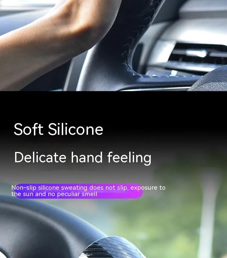 Black silicone steering wheel assist ball with metal bearing booster on a car steering wheel.