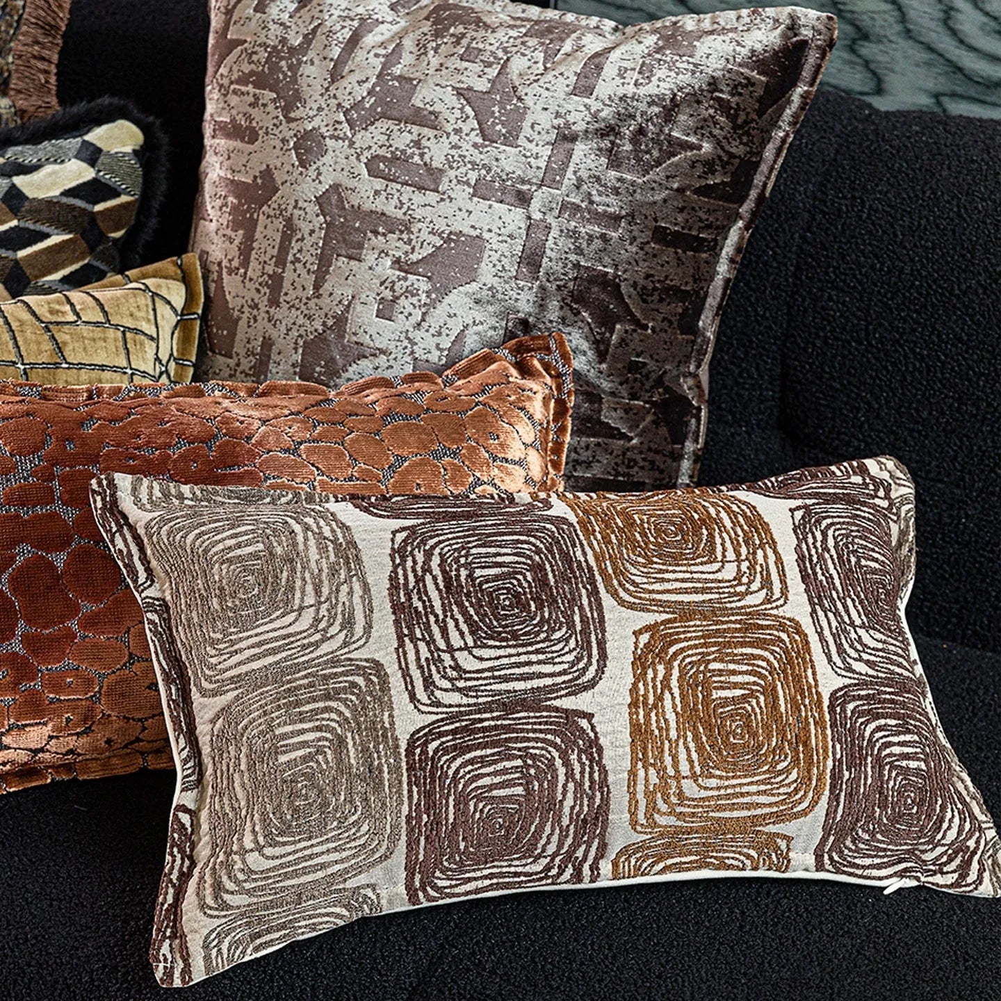 Abstract geometric coil pattern pillow cover in cream and coffee colours on textured fabric