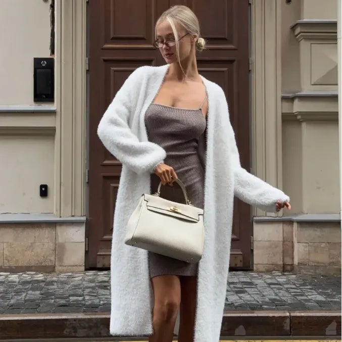 White women's sweater cardigan jacket with extended length and loose fit design