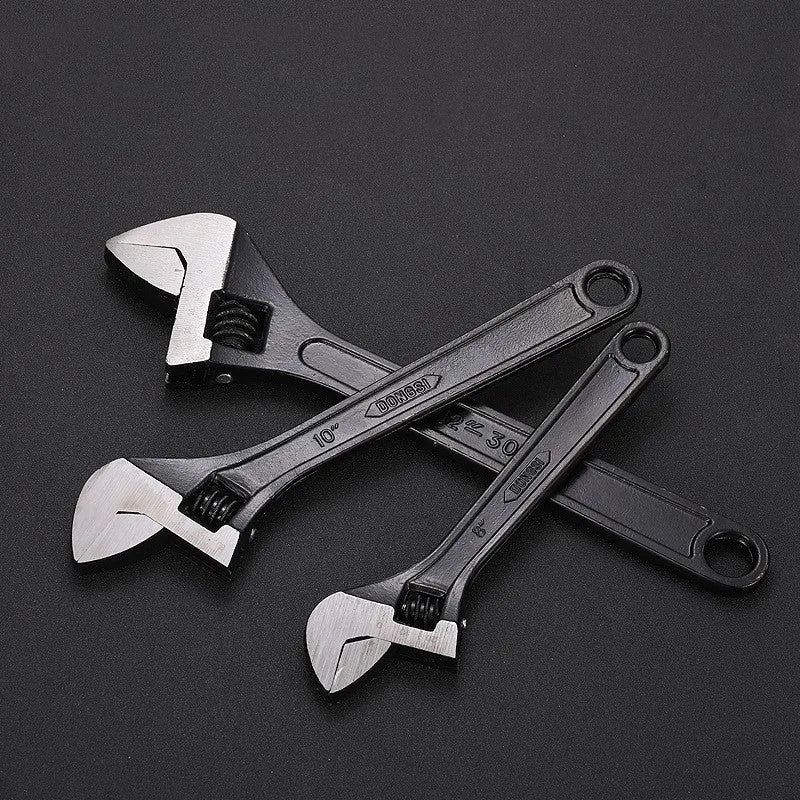 Stainless steel adjustable open-end wrench with blackened finish showing adjustment mechanism and four size options