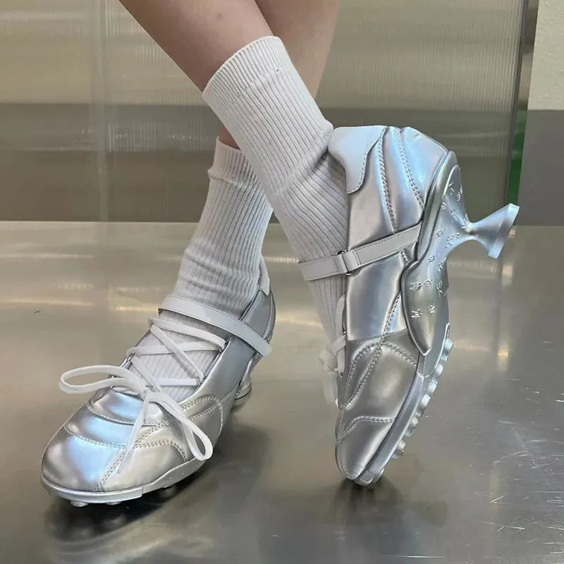 Women's silver lace-up sports shoes with a decorative bow and platform sole, showing round toe and low-top design.