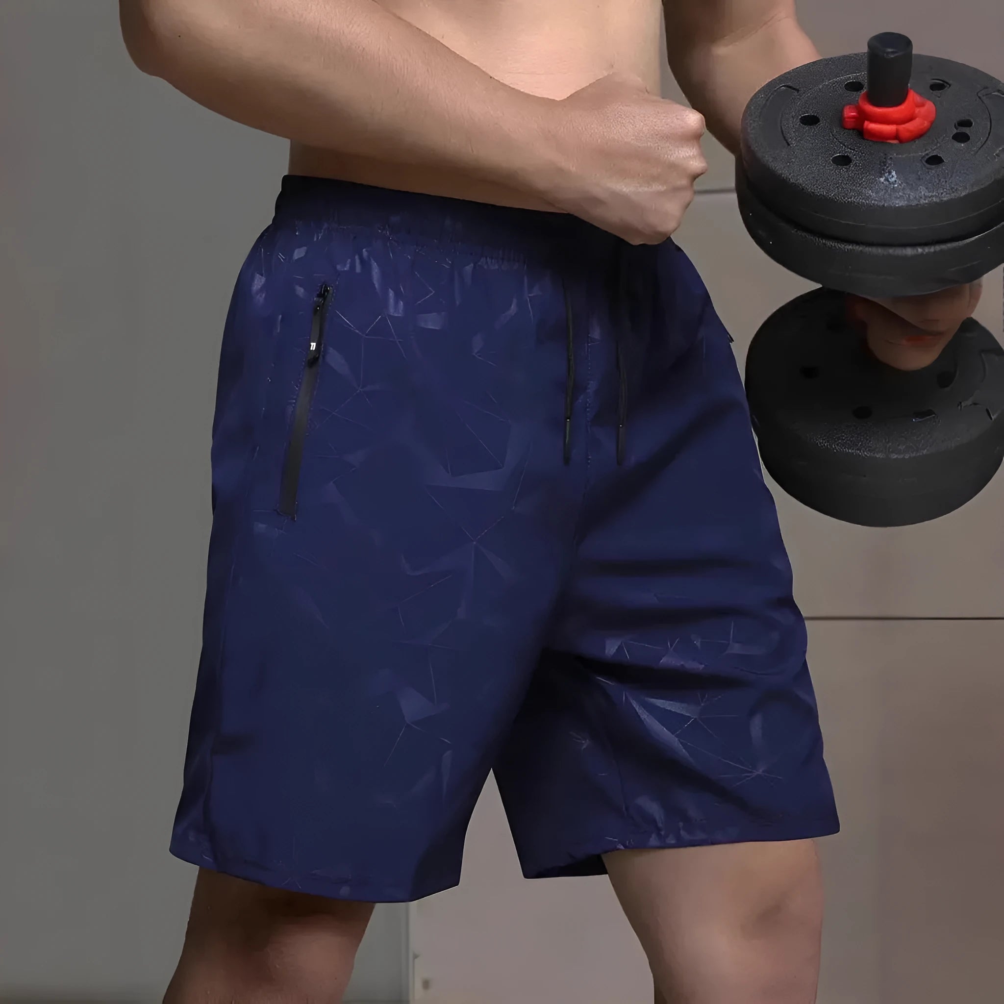 Man wearing loose grey polyester sports shorts with an elastic waistband.