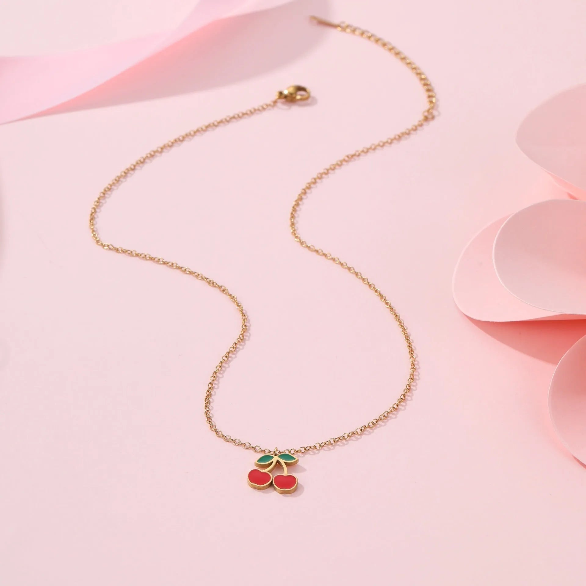 Complete cherry jewellery set showing stainless steel necklace, bracelet, earrings and ring with 18K electroplated finish