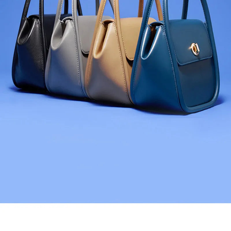 A soft cow leather wing-shaped tote handbag with a buckle and shoulder strap in black.