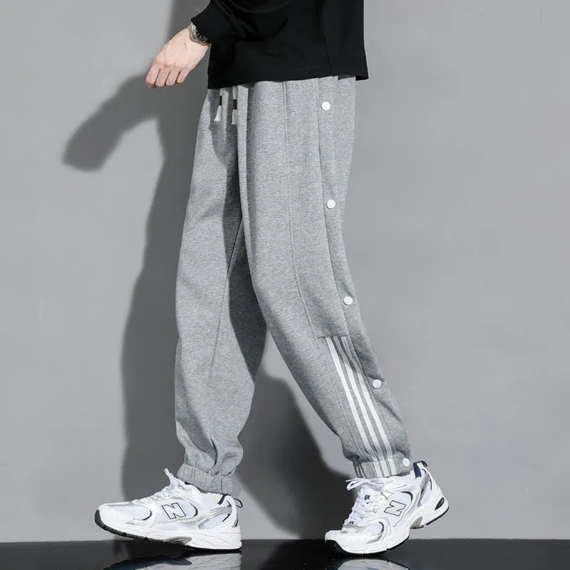 Men's loose fit cotton blend sports pants with high waist and ankle-tied cuffs in solid colours