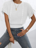 Loose white knitted pullover sweater with detailed twisted string ruffled short sleeves, round neck.