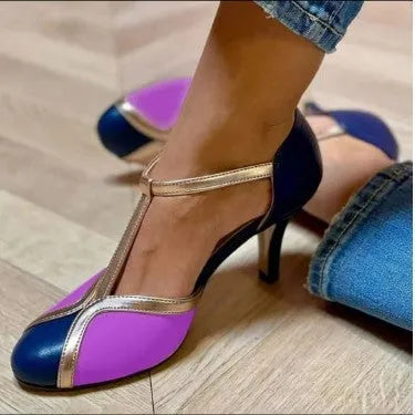 Women's round toe high heel in light blue pink with button fastening, shown in large size.