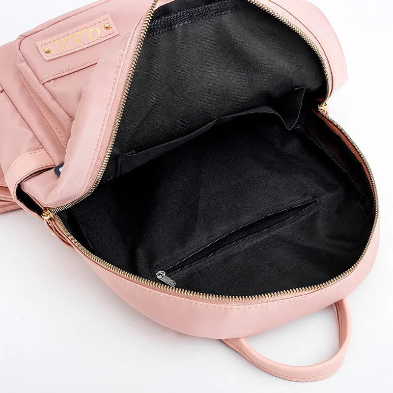 Women's black nylon backpack with waterproof lining and multiple zippered compartments