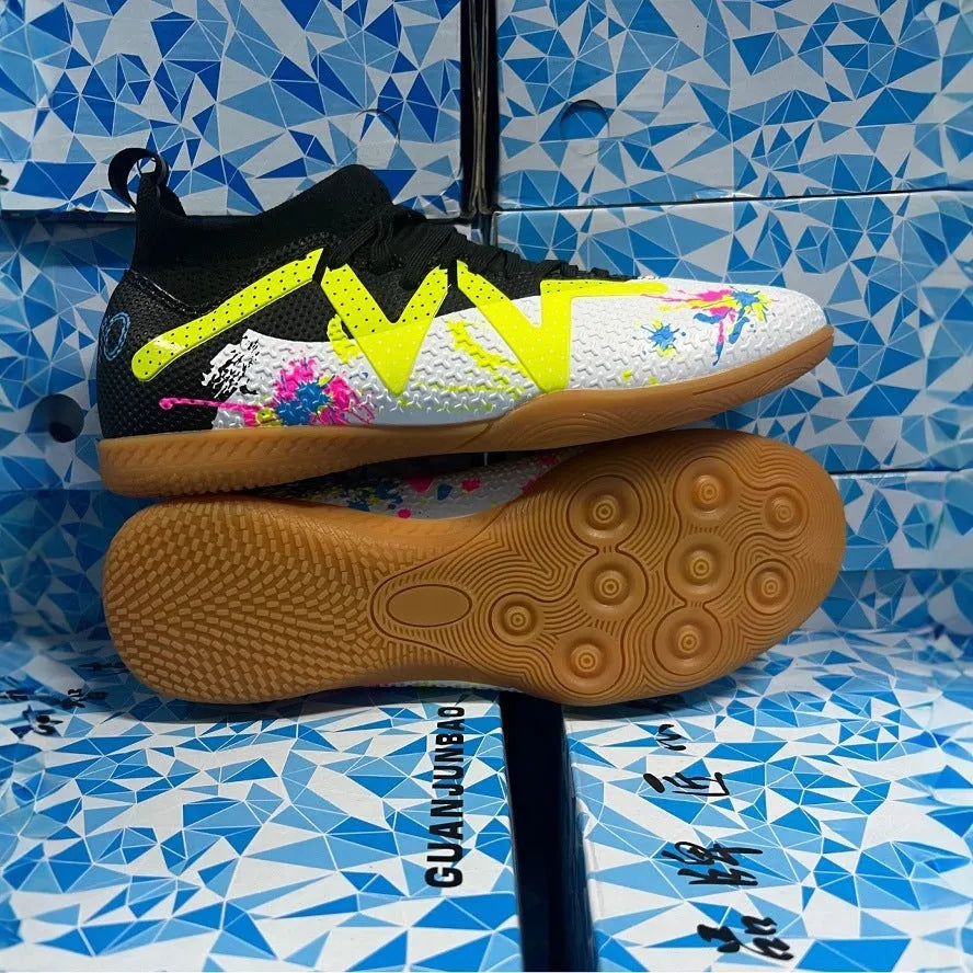 Lining low-top football boots in black and yellow with spiked rubber sole, showing mesh and PVC upper construction.