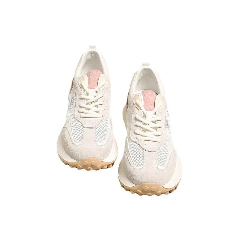 Women's grey retro sneaker with round toe and rubber sole showing mesh lining interior