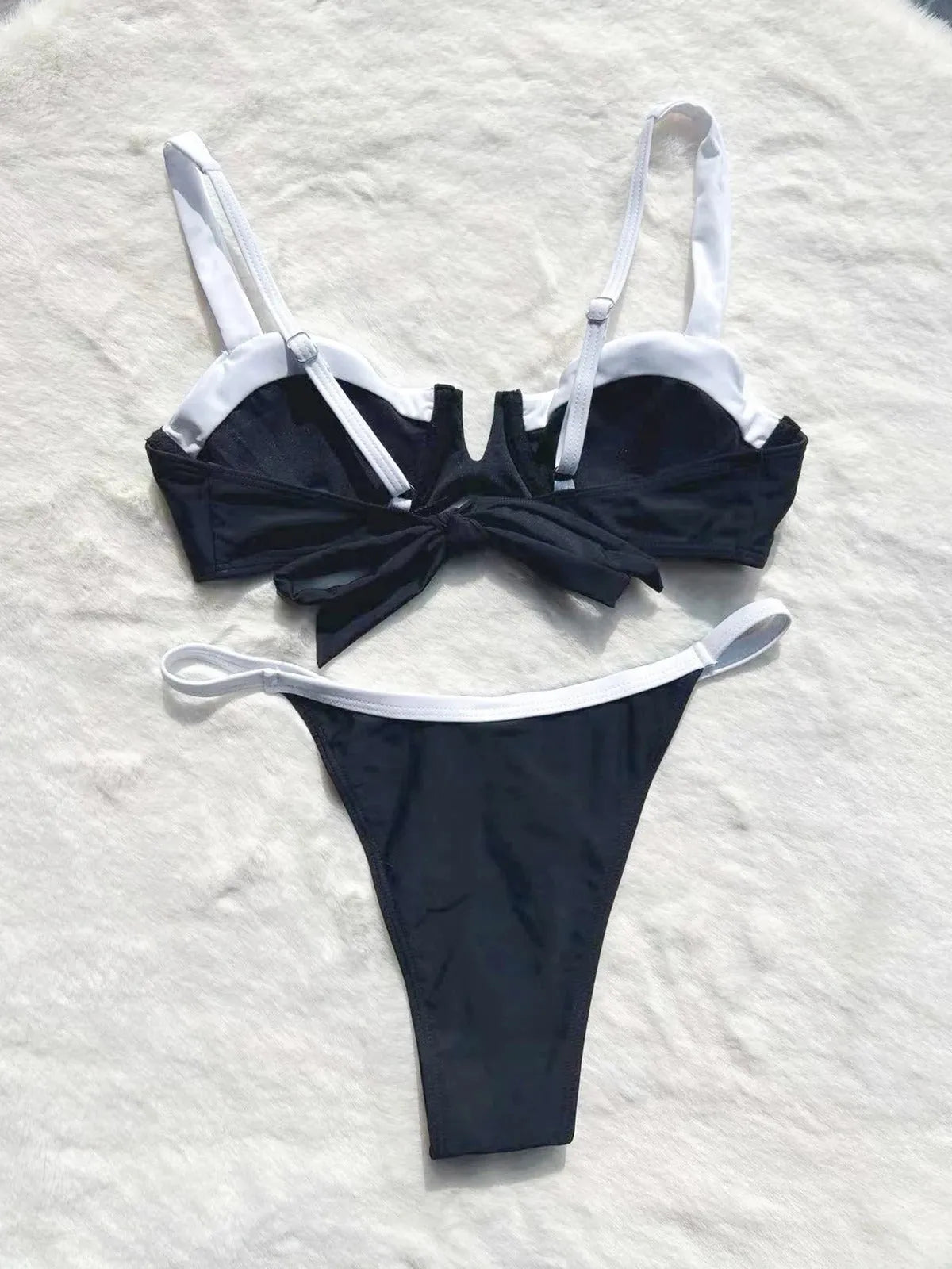 Women's black low waist bikini swimsuit with stitching detail and split brief design
