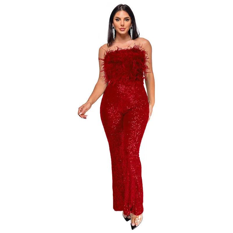 Woman wearing a black sleeveless backless jumpsuit with sequined top and flared legs.