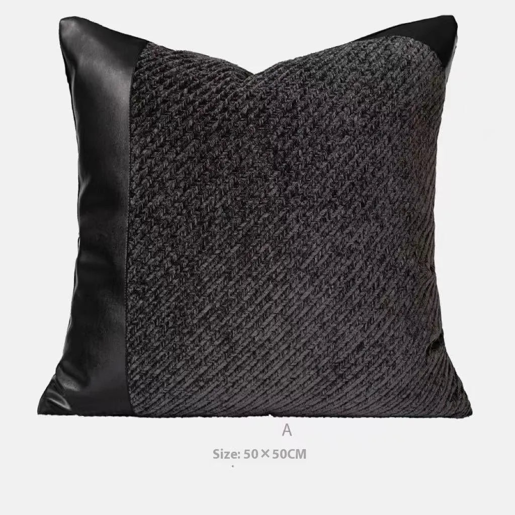 Grey and white plaid polyester bed runner blanket with matching pillowcase and leather round pillow on a double bed.