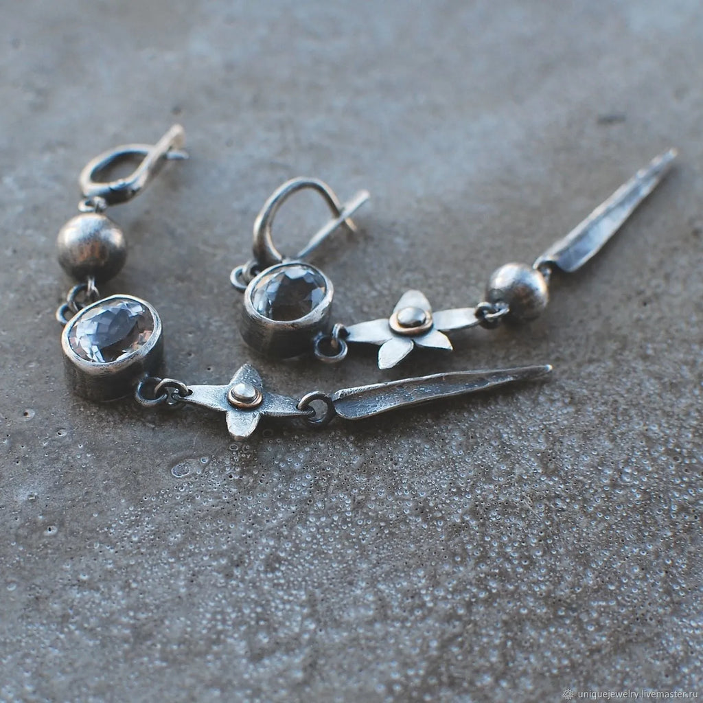 Pair of Hesheng geometric long drop earrings with antique silver XINGX pendant and rhinestones.