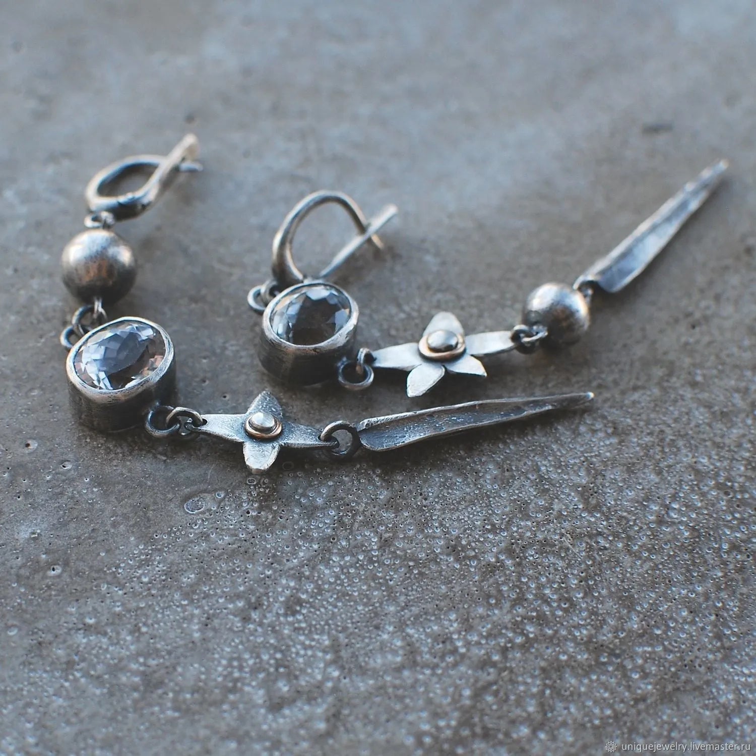 Pair of Hesheng geometric long drop earrings with antique silver XINGX pendant and rhinestones.