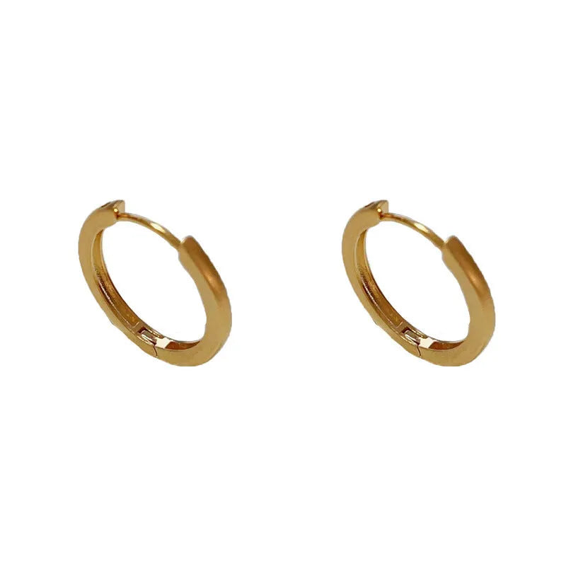 Geometric eyelet ear clips with circular design in gold or silver tone