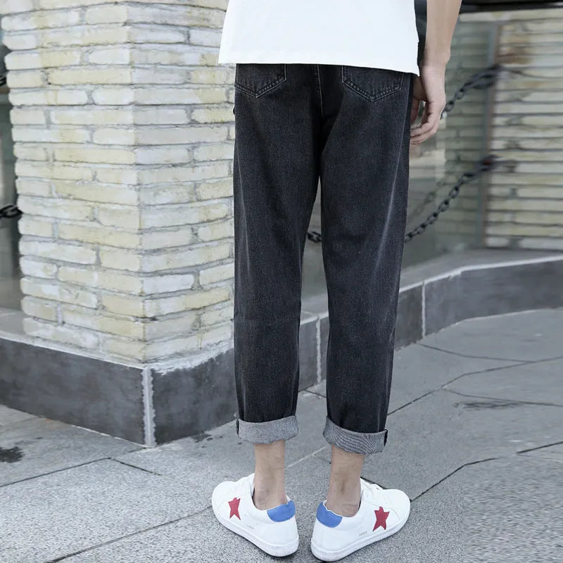 Men's black loose straight-leg jeans with small harem opening on hanger