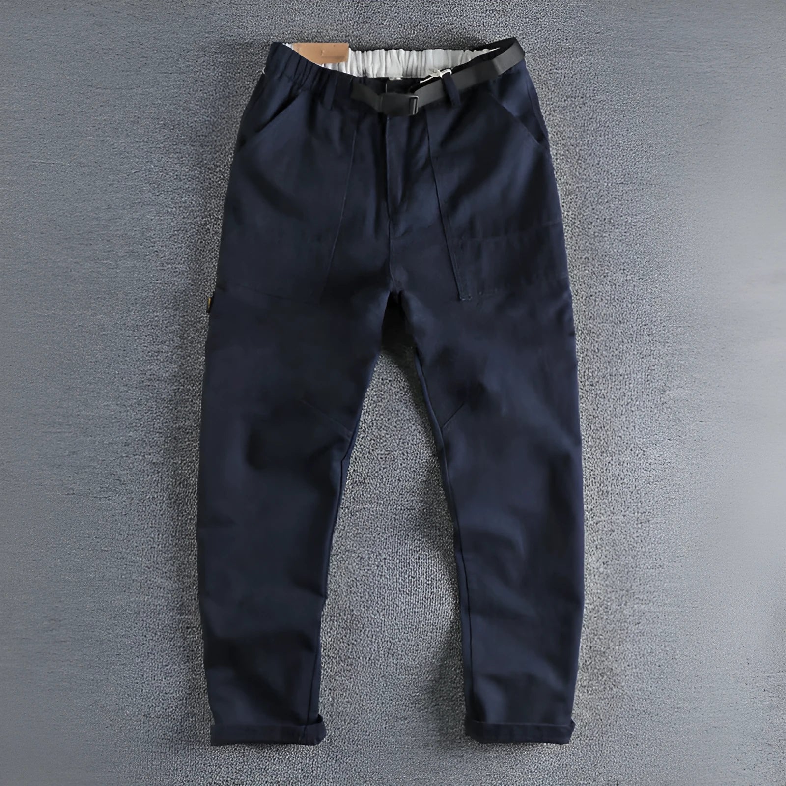 Men's khaki work trousers with a buckle belt and three-dimensional cutting on a hanger.