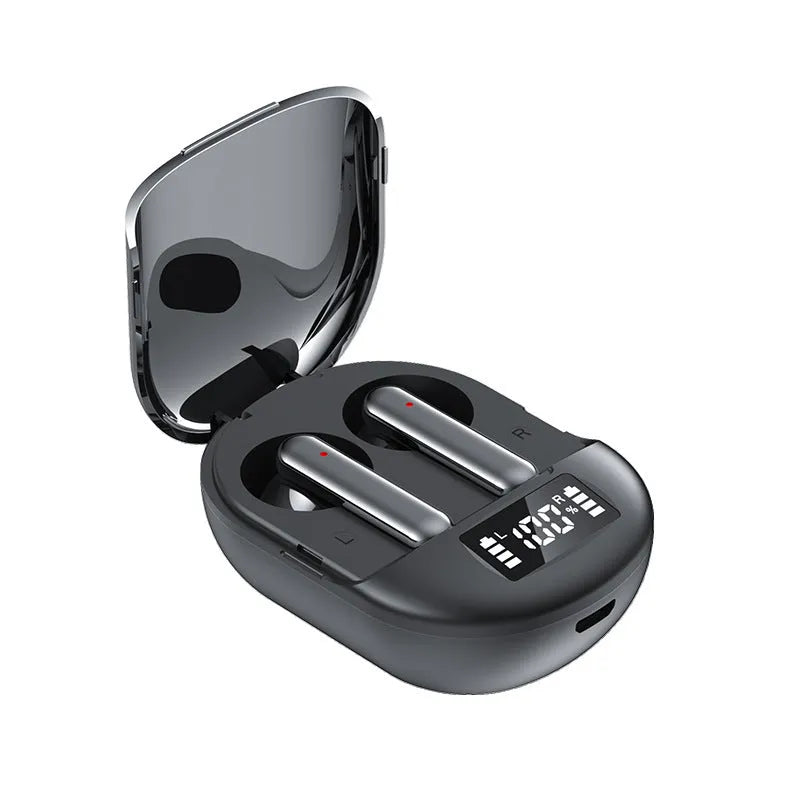 Black and white wireless Bluetooth in-ear headphones with a charging bin on a table.