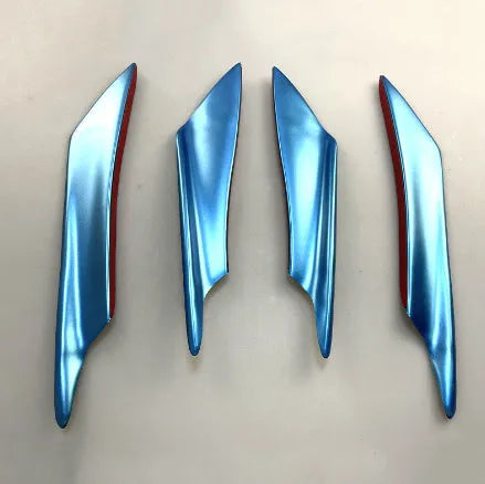 Set of four black ABS plastic bumper blade spoilers for car modification on a white background.