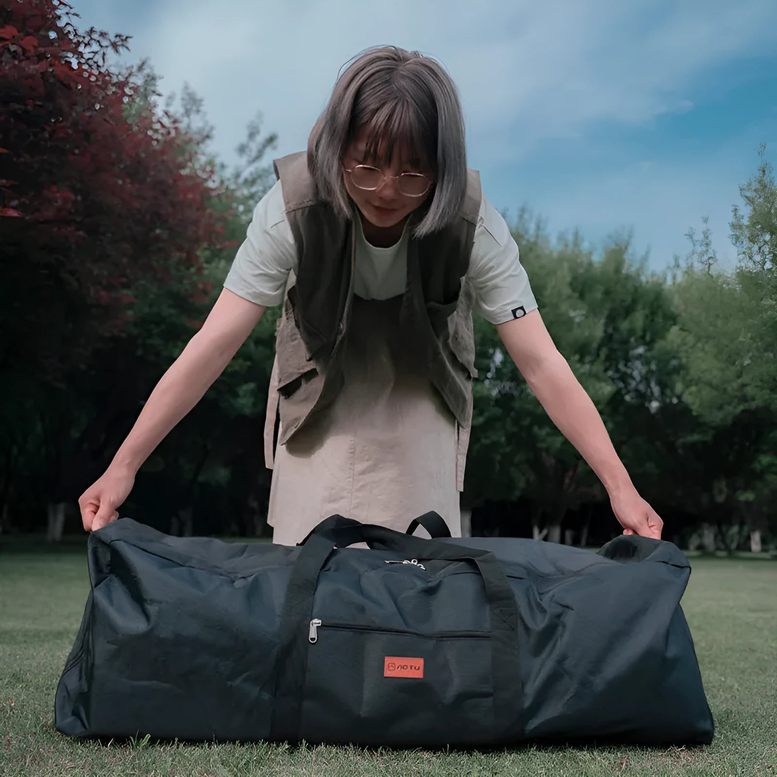 Green waterproof storage bag for camping tables and chairs with carrying handles
