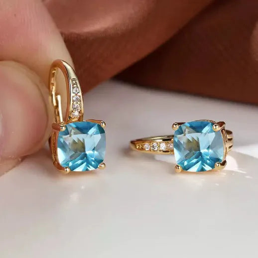 Square geometric ear clips with colourful moissanite stones in gold and silver electroplated finishes.