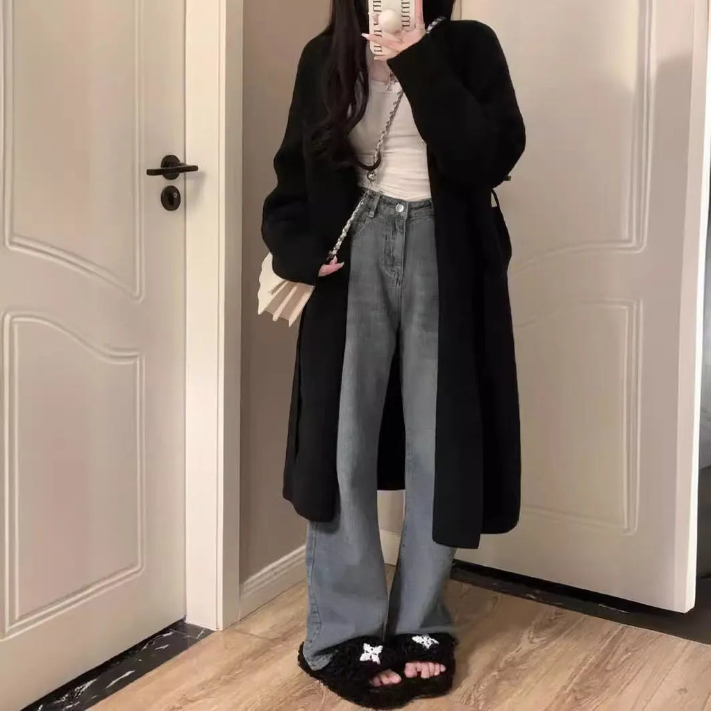 Women's knitted V-neck cardigan in loose fit showing mid-length silhouette and long sleeves