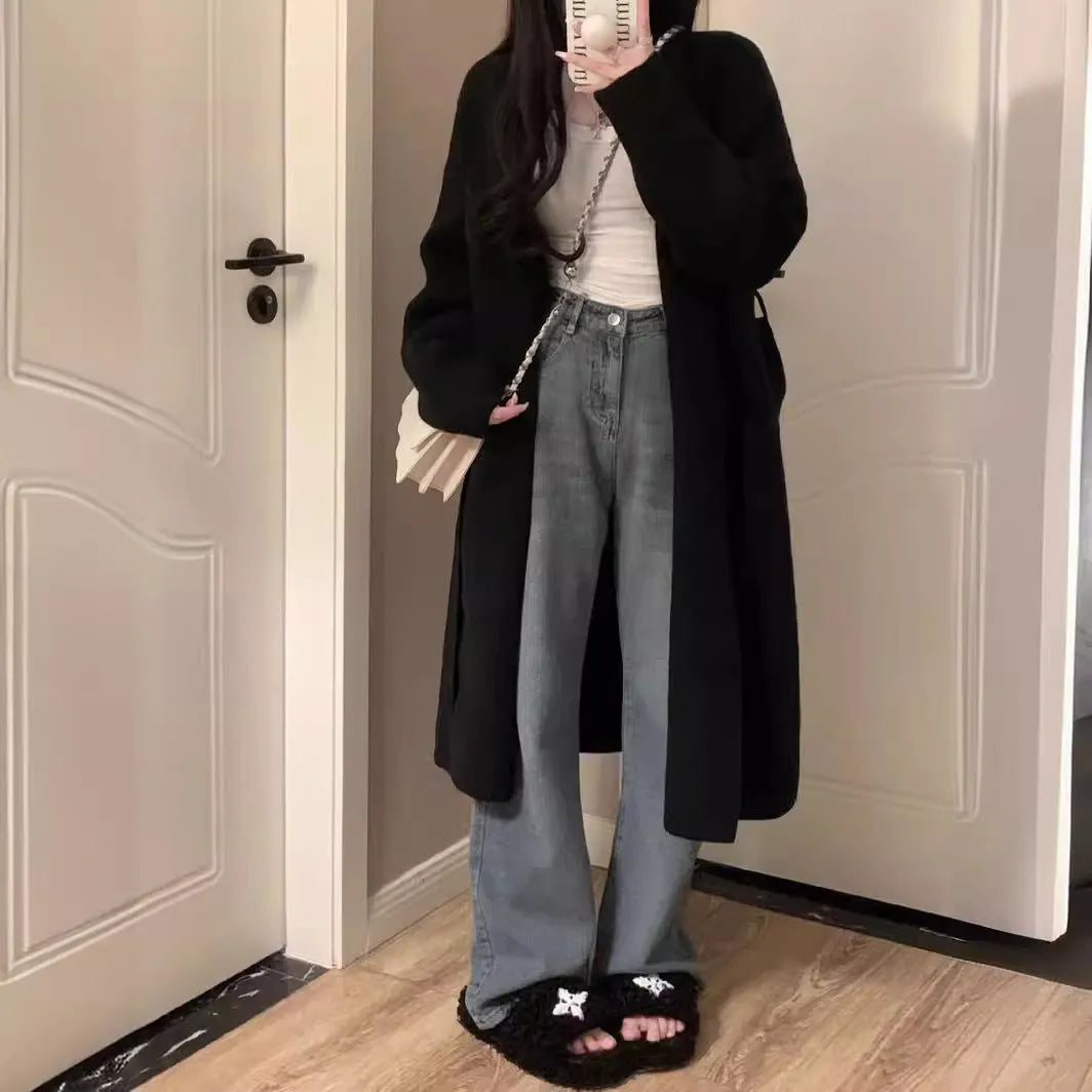 Women's knitted V-neck cardigan in loose fit showing mid-length silhouette and long sleeves