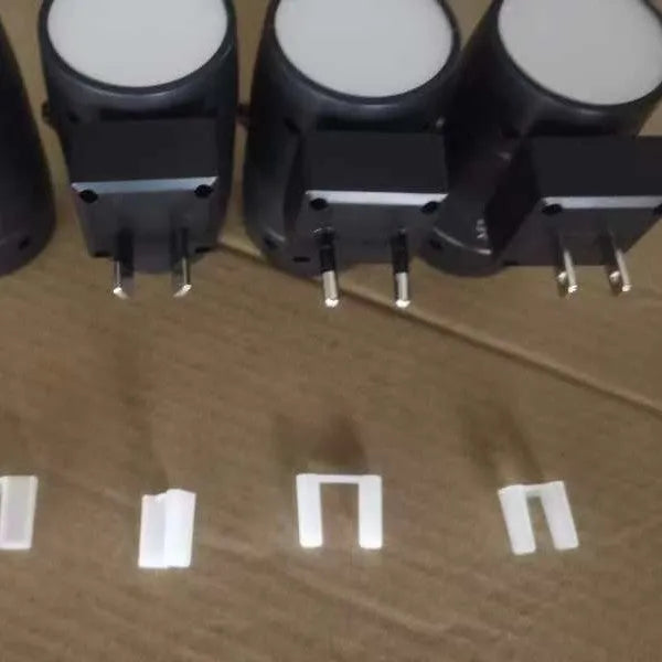 Small white plug-in night lamp with adjustable brightness control and rotatable light head