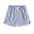 Children's patterned beach shorts in various colours including leopard print, floral, and fruit designs