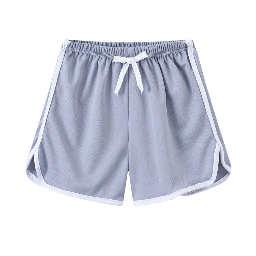 Children's patterned beach shorts in various colours including leopard print, floral, and fruit designs